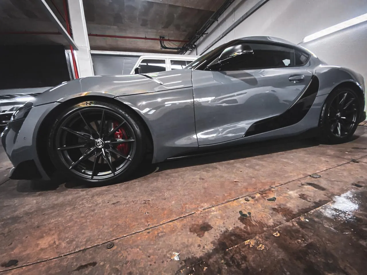 Grey Toyota Supra with matte black side accent wrap detailing