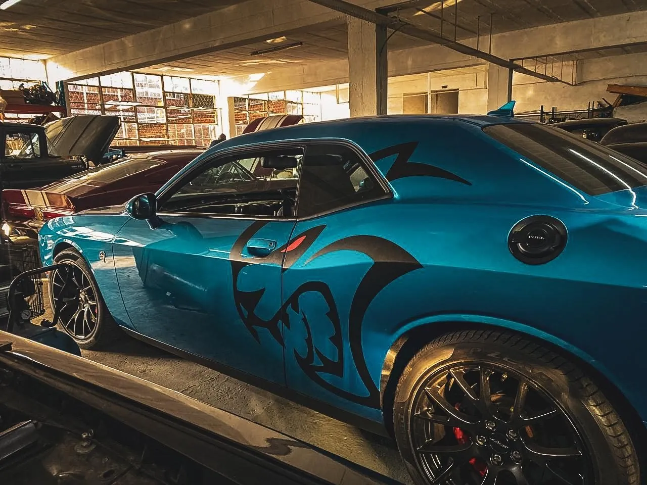 Blue Dodge Challenger with custom black Hellcat side graphics
